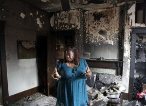 Deon Haywood standing in burnt building